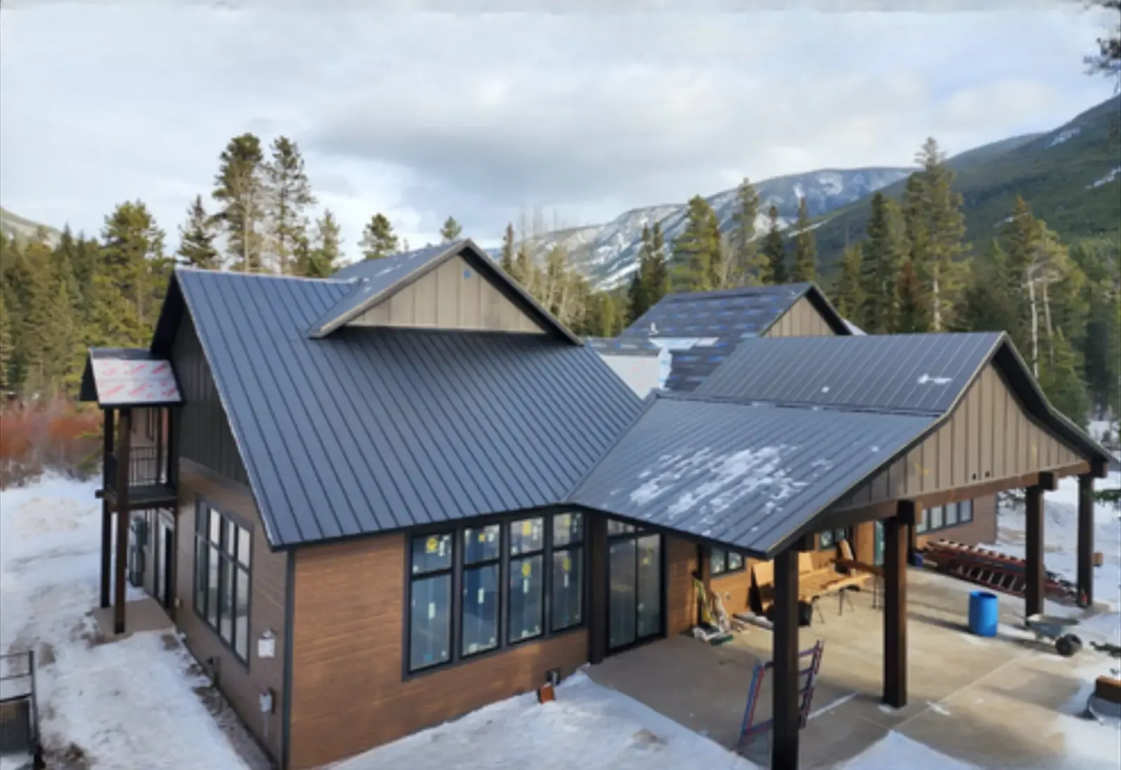 Mountain home with a new dark standing-seam metal roof