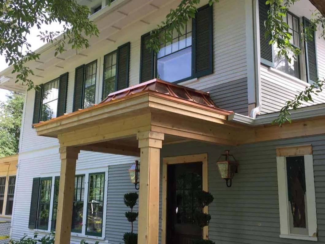 Home exterior with new windows, siding and a cedar porch cover
